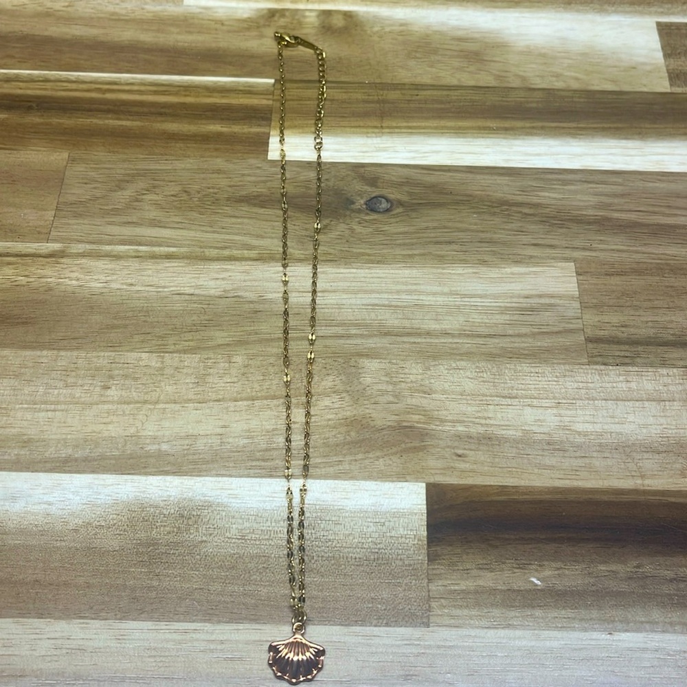 gold necklace with gold clam shell charm